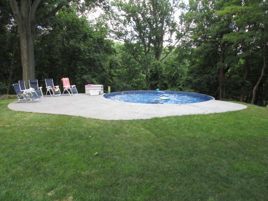 Above ground pool installation with surrounding hardscape and access detailing